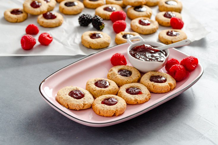 https://www.spoonabilities.com/wp-content/uploads/2021/12/Almond-Thumbprint-Cookies-pink-plate.jpg